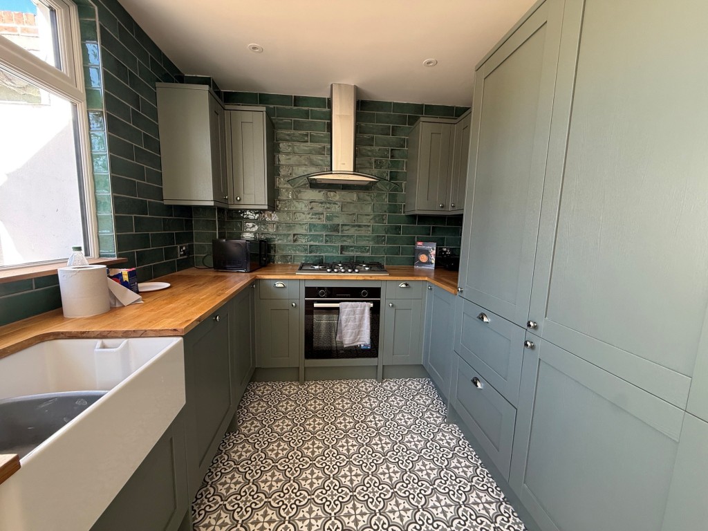Lot: 132 - THREE-BEDROOM TERRACE HOUSE - Modern but character fitted kitchen with window to rear